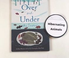 there is a book with an animal on it next to a sign that says over and under the snow