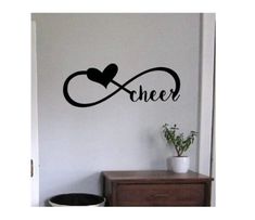 a wall decal with the word'cheer'and a heart on it in black