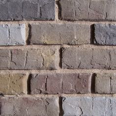 a brick wall that is made out of different colored bricks