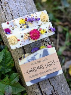 Christmas Lights is our bestselling holiday soap year after year! The most Christmas-y bar of the Holiday Collection, this soap is scented with spearmint, eucalyptus, & frankincense essential oils. I designed it to look like a string of brightly coloured Christmas lights shining on a blustery winter day! Topped with a variety of botanicals including homegrown gomphrena, statice flowers, and cornflowers as well as cranberry seeds & peppercorns. Beautiful natural blue swirls of indigo against a wh Statice Flowers, Lavender Christmas, Eco Friendly Christmas Gifts, Palmarosa Essential Oil, Soap Collection, Star Christmas Lights, Holiday Soap, Christmas Soap, Eco Friendly Christmas