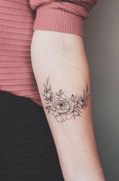 a woman with a flower tattoo on her arm