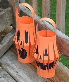 two orange paper lanterns sitting on top of a wooden deck