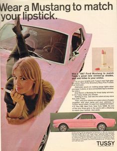 a woman leaning on the hood of a pink car with an advertisement for tussy