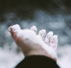 a person holding out their hand with snow on it