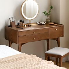 a wooden desk with a mirror and stool next to it