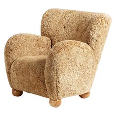 a chair made out of sheep's wool with wooden legs and feet on an isolated white background