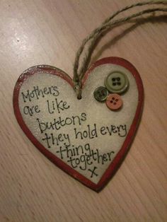 a heart shaped ornament with buttons attached to it that says, mothers are like buttons they hold every finger together