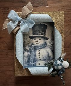 a christmas card with a snowman wearing a top hat and scarf on the front