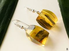 "Clear golden amber earrings in original rectangle shape are a perfect gift for nature and its colors lovers. These natural amber earrings could really boost your confidence, so wear them carefully! There are three different pairs of earrings, so choose wisely which ones suit you the best! MATERIALS AND SIZE: Stone: 100% Natural Baltic Amber Findings: Sterling silver 925 Earrings A: Weight: 4,6 g (0,16 oz) Bead size: 1,7 cm (0,66 in) x 1,4 cm (0,55 in) Total earring length: 3,5 cm (1,37 in) Earr Handmade Amber Jewelry At Affordable Prices, Luxury Amber Earrings For Formal Occasions, Cheap Amber Drop Earrings, Amber Light, Golden Logo, Amber Lights, Golden Amber, Cognac Color, Color Earrings