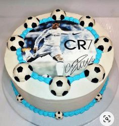 a cake with soccer balls on it and the name cr7 written in frosting