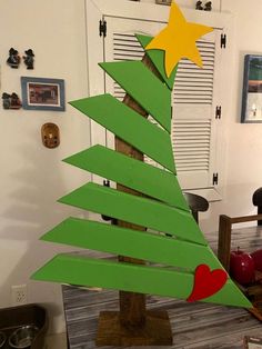 a christmas tree made out of cardboard sitting on top of a wooden table