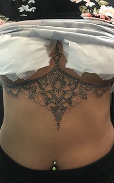 the back of a woman's stomach with torn paper on it