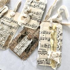 four tags with musical notes on them and some strings attached to the back of them