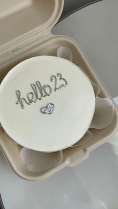 there is a cake in the shape of a heart on it's plate that says hello 23