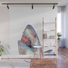 a painting of a shark with its mouth open on the wall in a living room