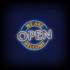 we are open neon sign on brick wall