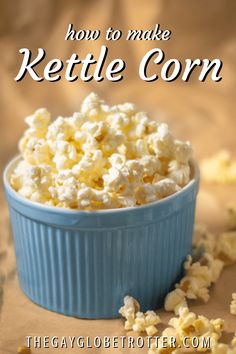 a blue bowl filled with popcorn on top of a table