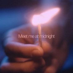 someone holding a lit match in their hand with the words meet me at midnight on it