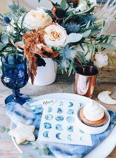 a plate with cupcakes and flowers on it