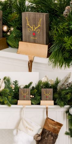 christmas stockings hanging from the mantel in front of a fireplace