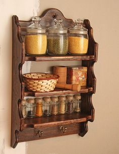 an old wooden spice rack with jars and spices