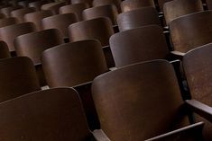 rows of brown chairs in an empty auditorium