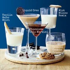 several different types of drinks on a tray with cookies and milk in the bottom row