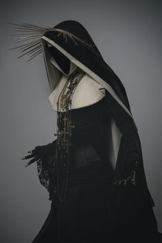 a mannequin dressed in black and white with a hood on it's head