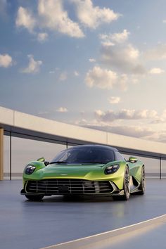 a green sports car parked on the side of a road