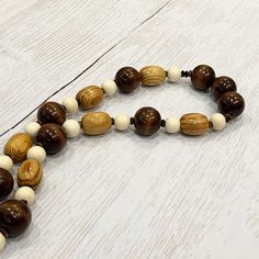 Wood Bead Necklace, Multicolor Wood Necklace Unisex Wood Necklace, Chunky Wood Necklace, Mens Wood Necklace, Womens Wood Beaded Necklace This unique necklace was hand beaded using a mix of large 25mm round dark brown wooden beads, 14mm round natural pine beads, 25mm round caramel colored wooden barrel beads, and faceted dark brown Czech glass rondelles in a fresh, modern design. The necklace measures approximately 26 inches long and is securely fastened with a silver lobster clasp. Perfect for a Wooden Beaded Necklaces With Round Beads, Natural Wooden Beads Necklace, Brown Round Beaded Necklace With Large Beads, Brown Beaded Necklace With Large Round Beads, Artisan Brown Beaded Necklaces With 8mm Beads, Natural Wood Necklaces With Wooden Beads, Wooden Beads Necklace With Round Beads, Brown Wood Bead Necklaces, Brown Wooden Beaded Necklace With Round Beads