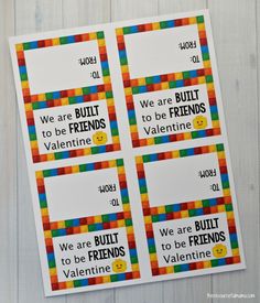 two stickers with words that say we are built to be friends, and one is made out of legos