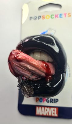 a close up of a person's mouth with blood dripping out of the tongue