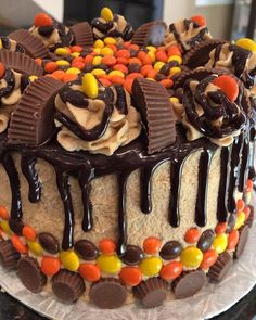 a cake decorated with chocolate, candy and candy bar toppings on top of it