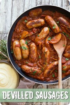 a skillet filled with cooked sausages and sauce