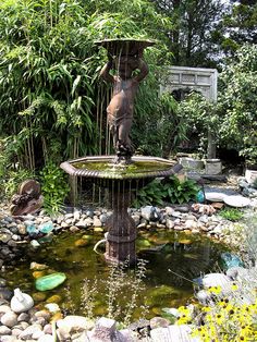 a small fountain in the middle of a garden