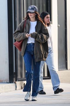 two women walking down the street together