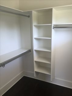 an empty closet with white walls and shelves