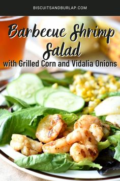 grilled shrimp salad with grilled corn and veggies on a white plate