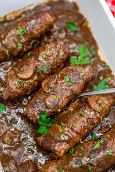 the meat is covered in gravy and garnished with fresh parsley