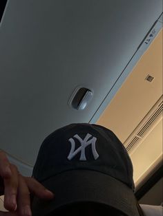 a new york yankees hat hanging from the ceiling