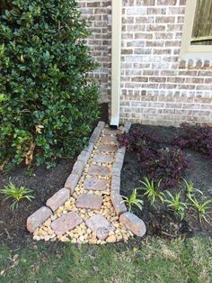 a brick walkway in front of a house