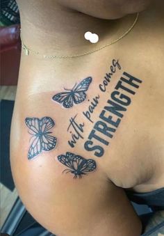 a woman's stomach with butterflies on it and the words strength written in black ink