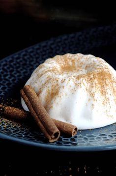 a dessert with cinnamon and whipped cream on a blue plate