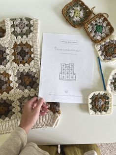 someone is working on their crocheted afghans with the instructions to make them