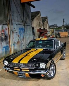 a black and yellow car parked in front of a building