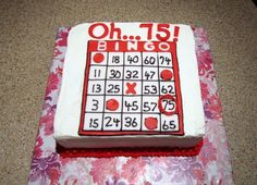 a cake that is sitting on top of a pink and white tablecloth with numbers