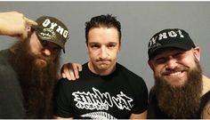 three men with long beards posing for the camera