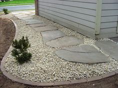 a stone walkway in front of a house