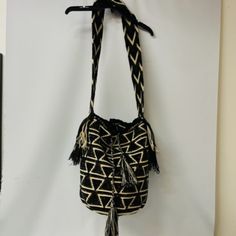 - Brown, Tan, And Black -Handwoven Bucket Style Bag -Wear Shoulder Or Cross-Body -Drawstring With Tassels -100% Acrylic Yarn And Glass Crystals -Handmade In Columbia -Comes With Extra Crystals Black Woven Straw Crossbody Bag, Black Bucket Straw Bag With Removable Pouch, Black Woven Satchel Straw Bag, Black Woven Straw Satchel Bag, Handmade Black Crossbody Bucket Bag, Black Woven Satchel For Travel, Weaving Bucket Bag For Travel, Black Woven Bucket Shoulder Bag, Black Woven Pouch Shoulder Bag