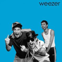 three men are posing for the camera in front of a blue background with words weezer on it